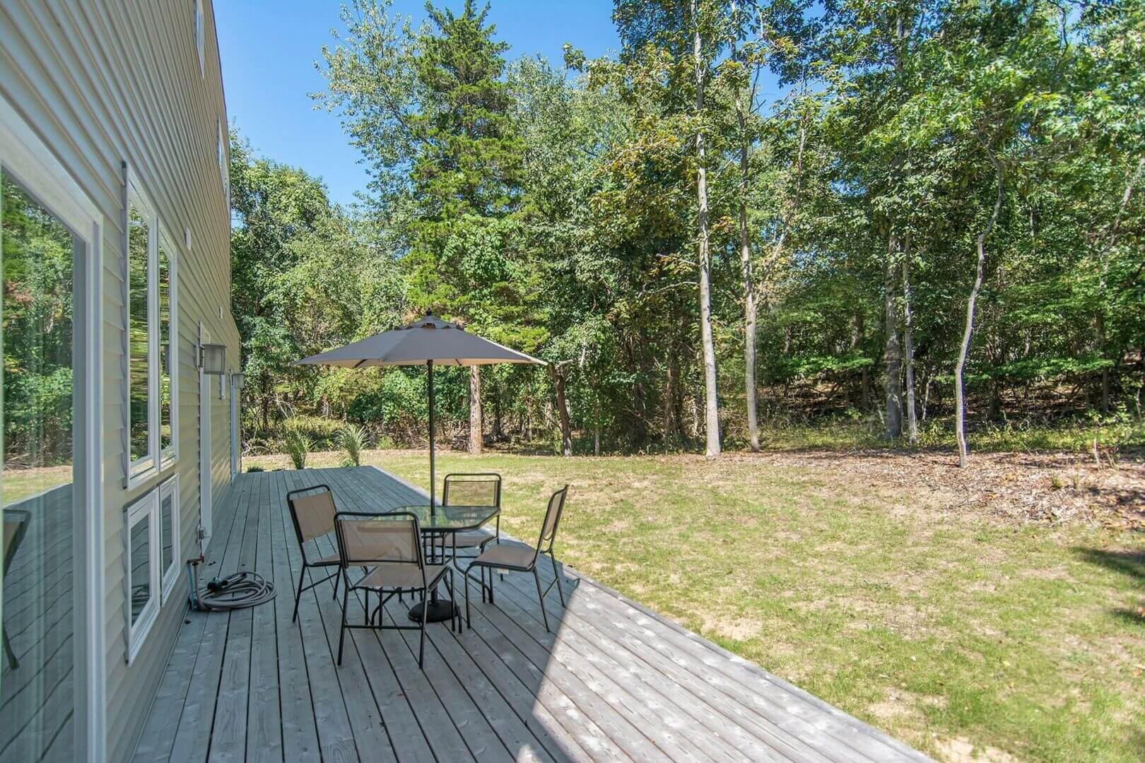 Wooden deck with patio table and umbrella