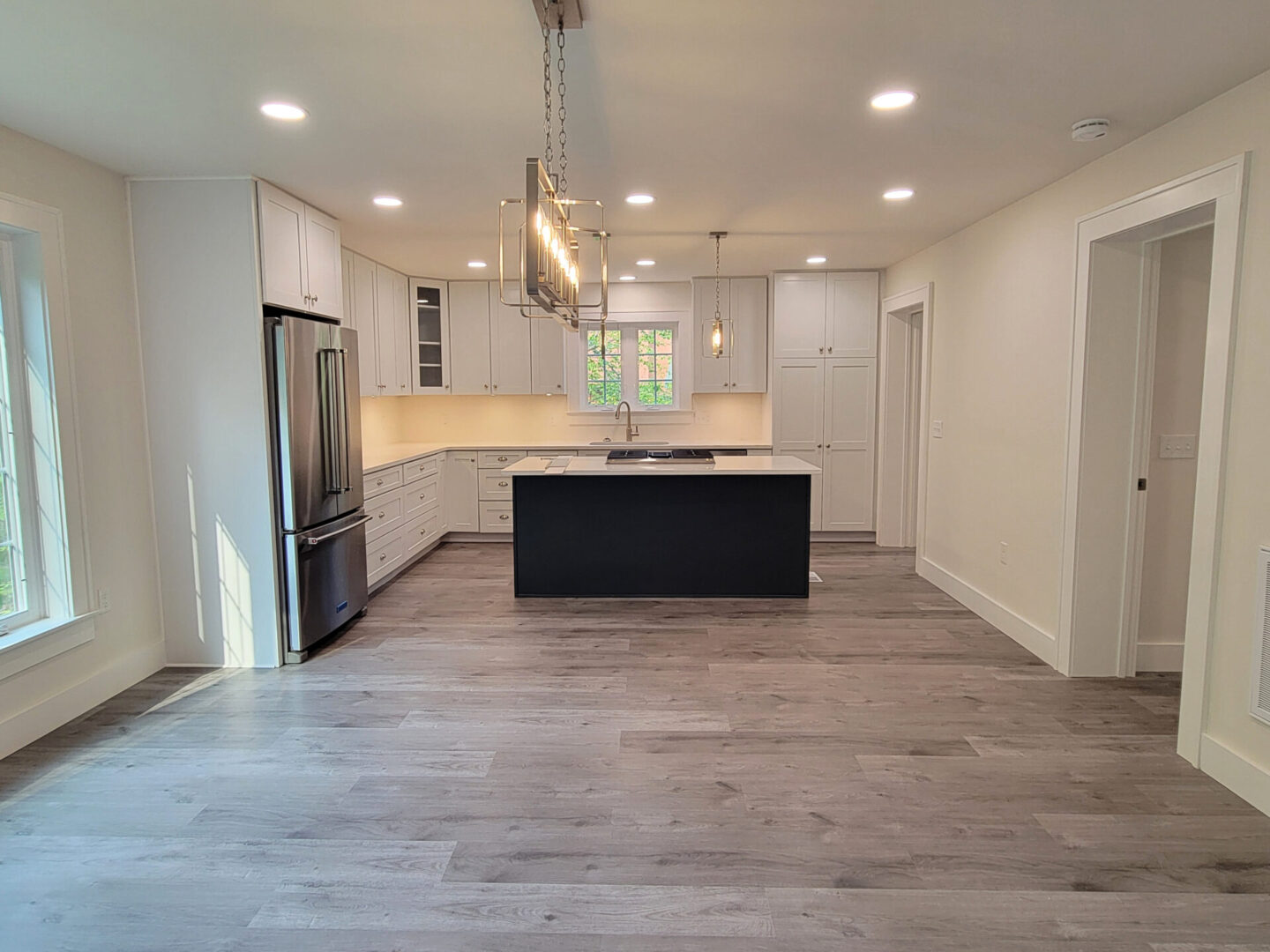 Modern kitchen with island and stainless steel appliances.