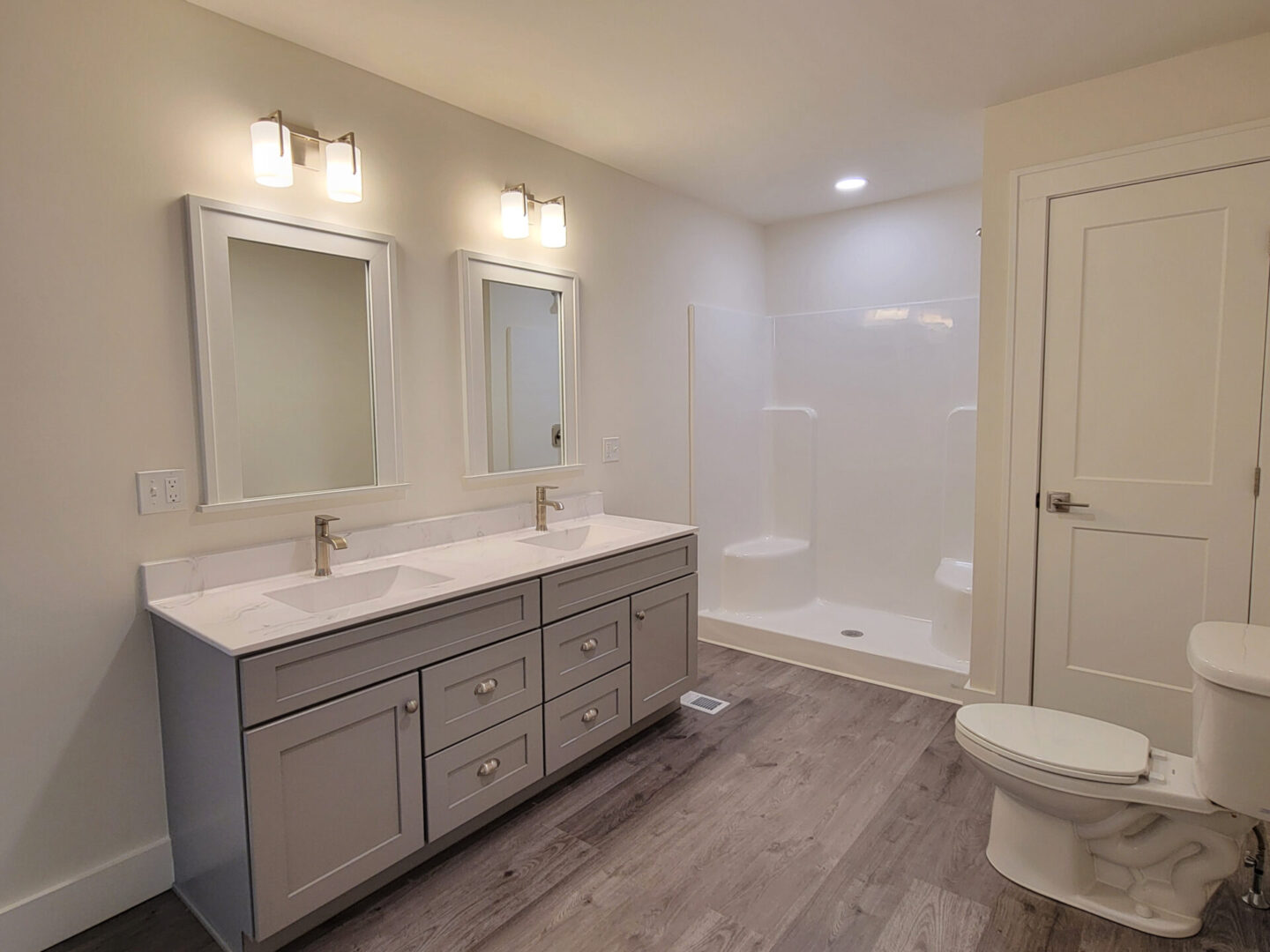 Modern bathroom with double vanity and shower.
