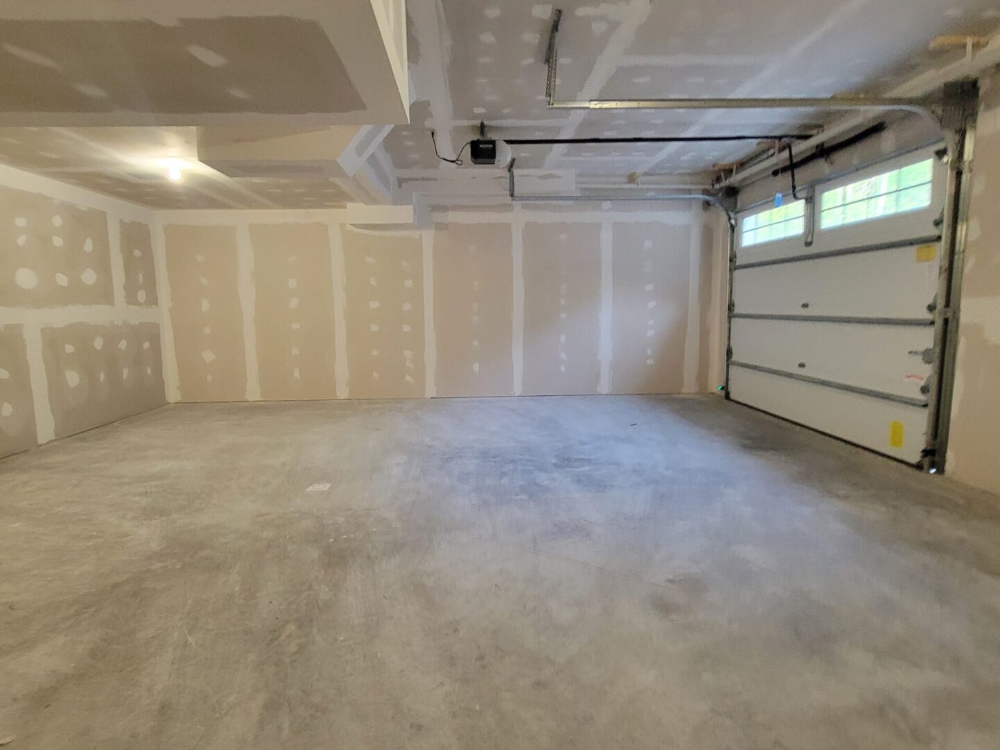 Empty garage with unfinished walls and floor.