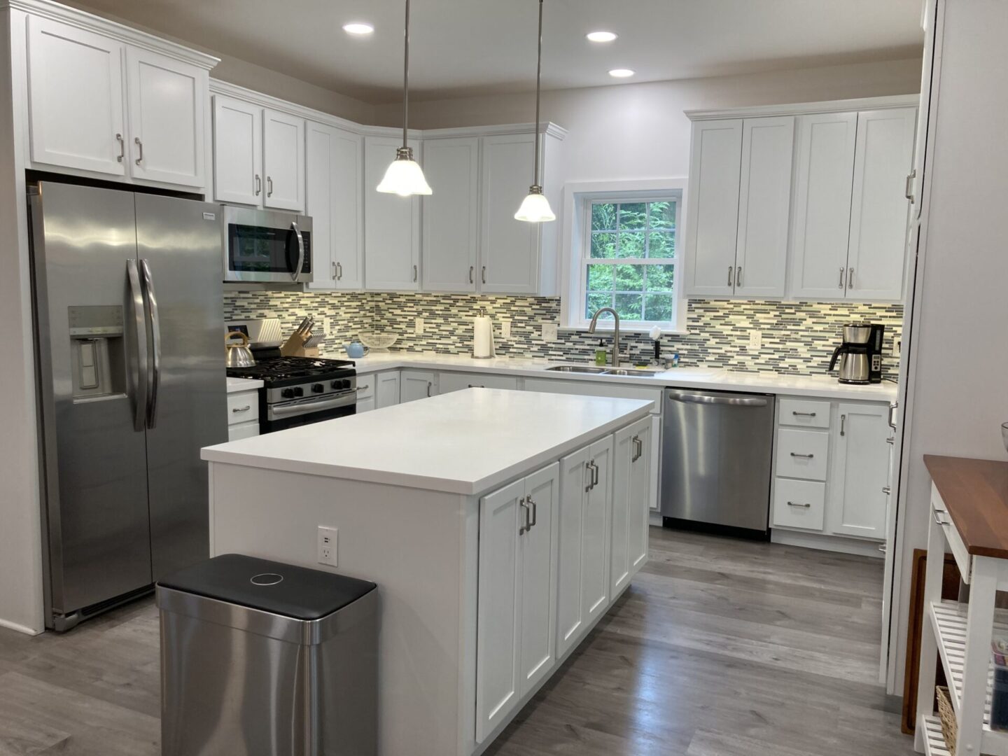 Modern kitchen with white cabinets and island.