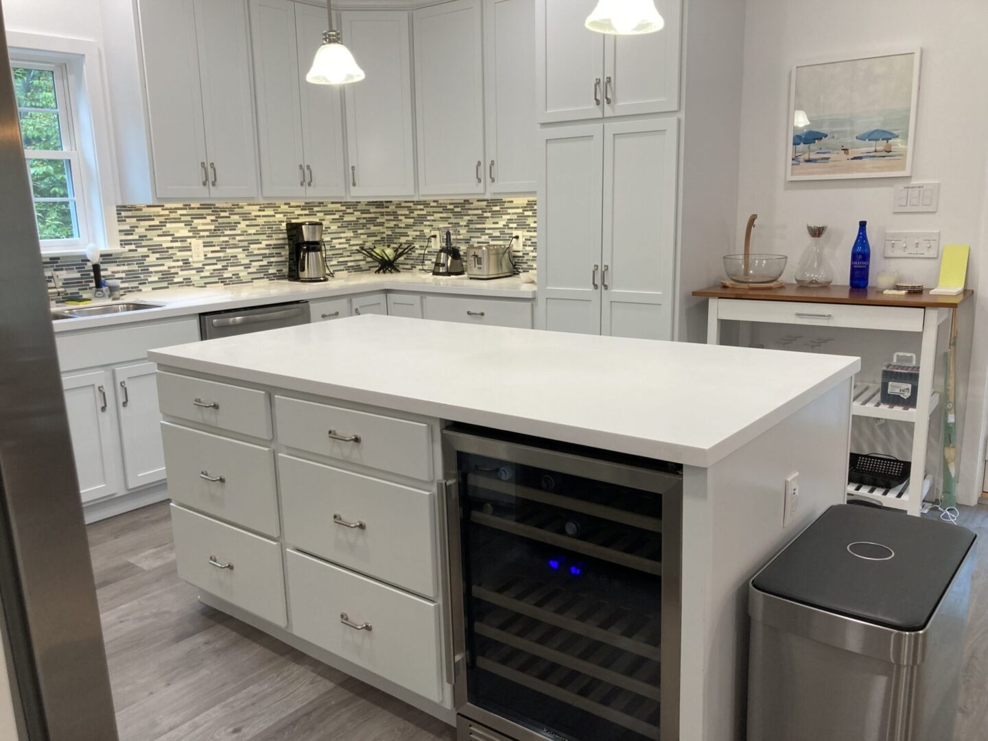White kitchen island with wine refrigerator