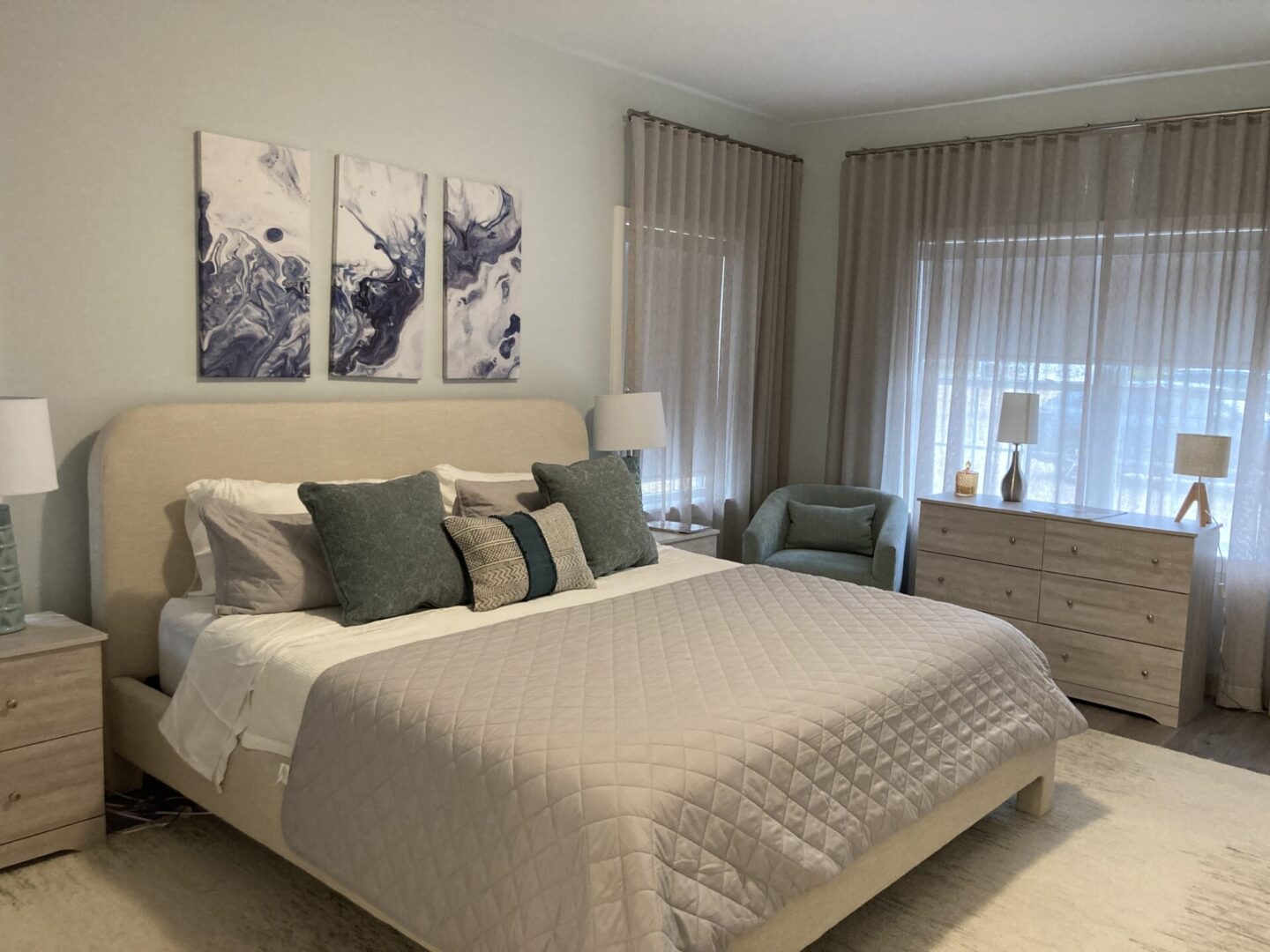 Modern bedroom with bed and abstract art.