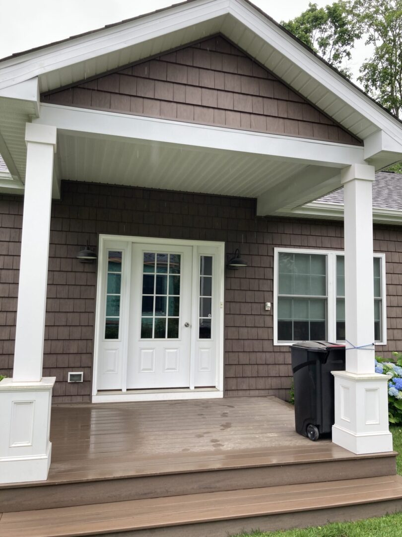 House entrance with porch and double doors.